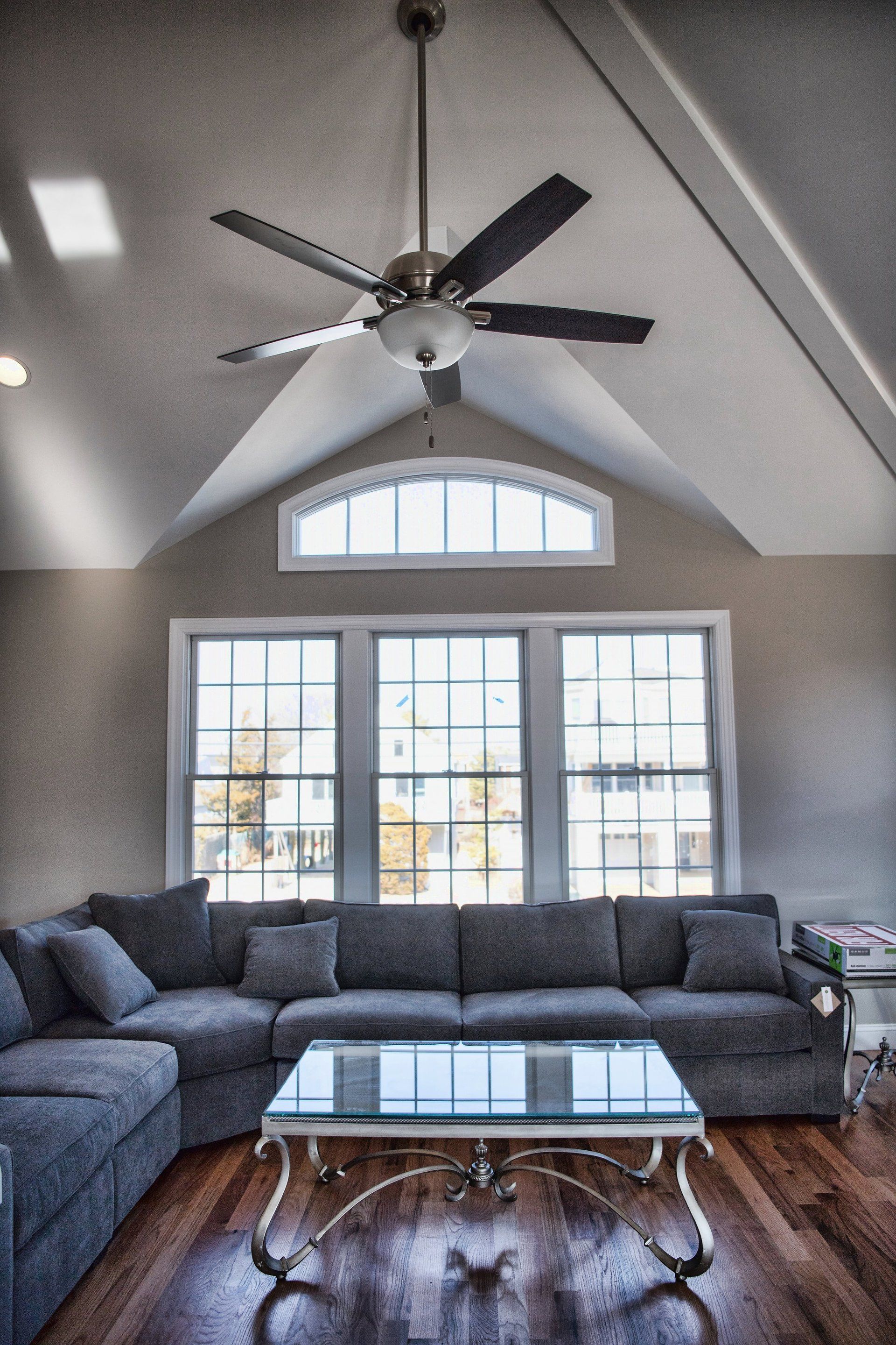 A living room with a couch and a ceiling fan