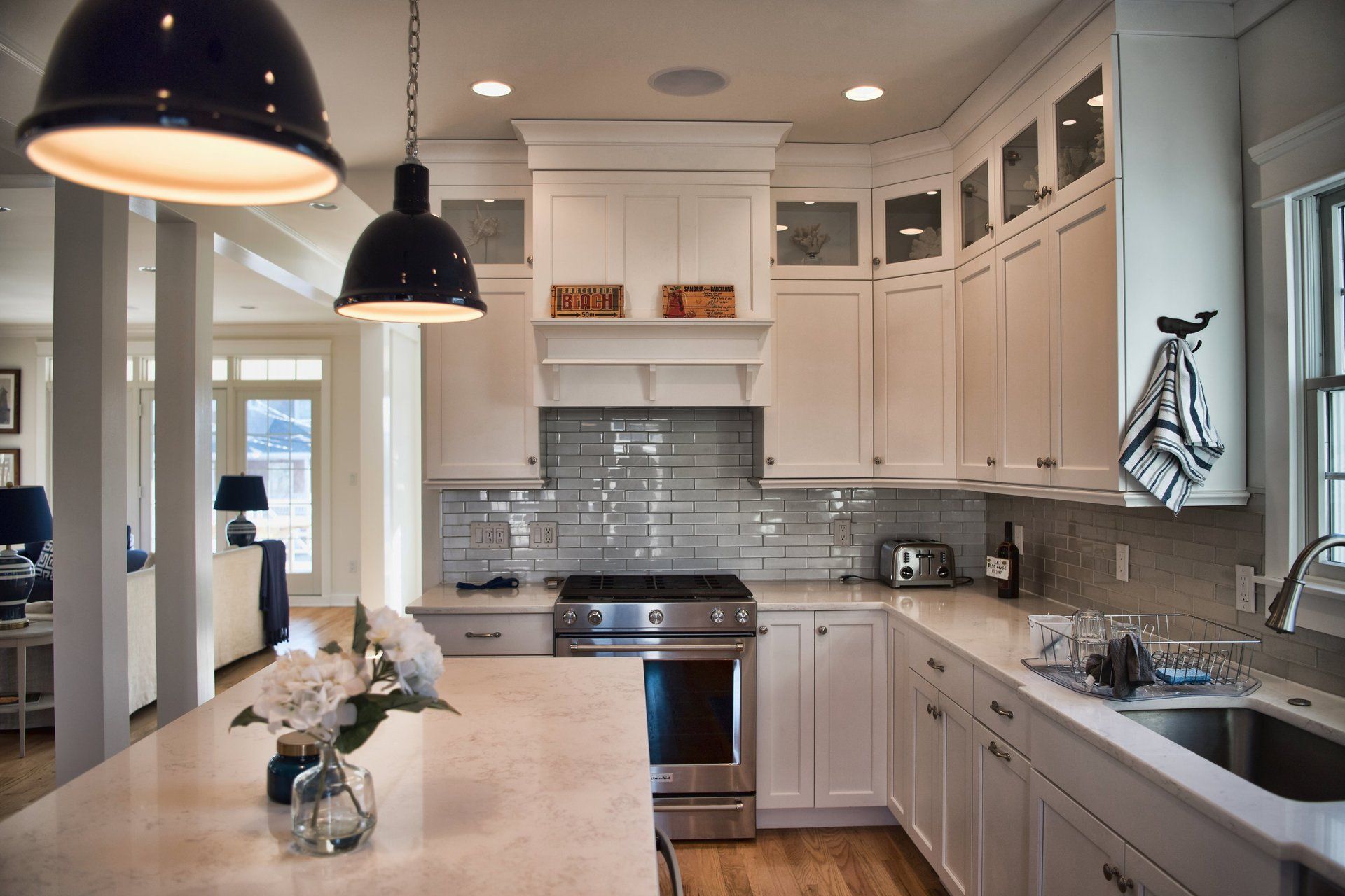 A kitchen with white cabinets and stainless steel appliances