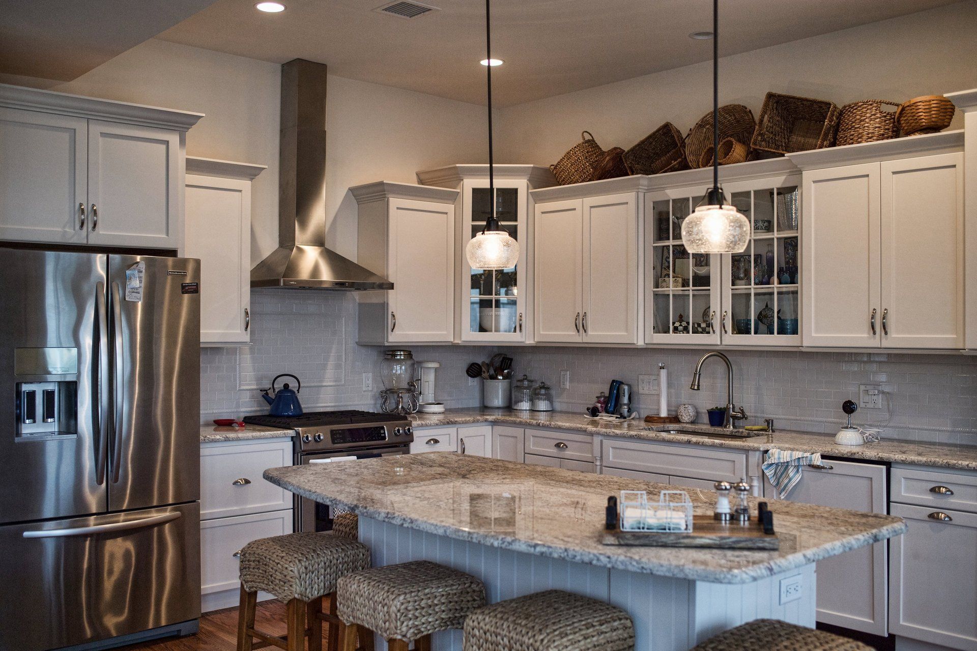 A kitchen with white cabinets and stainless steel appliances.