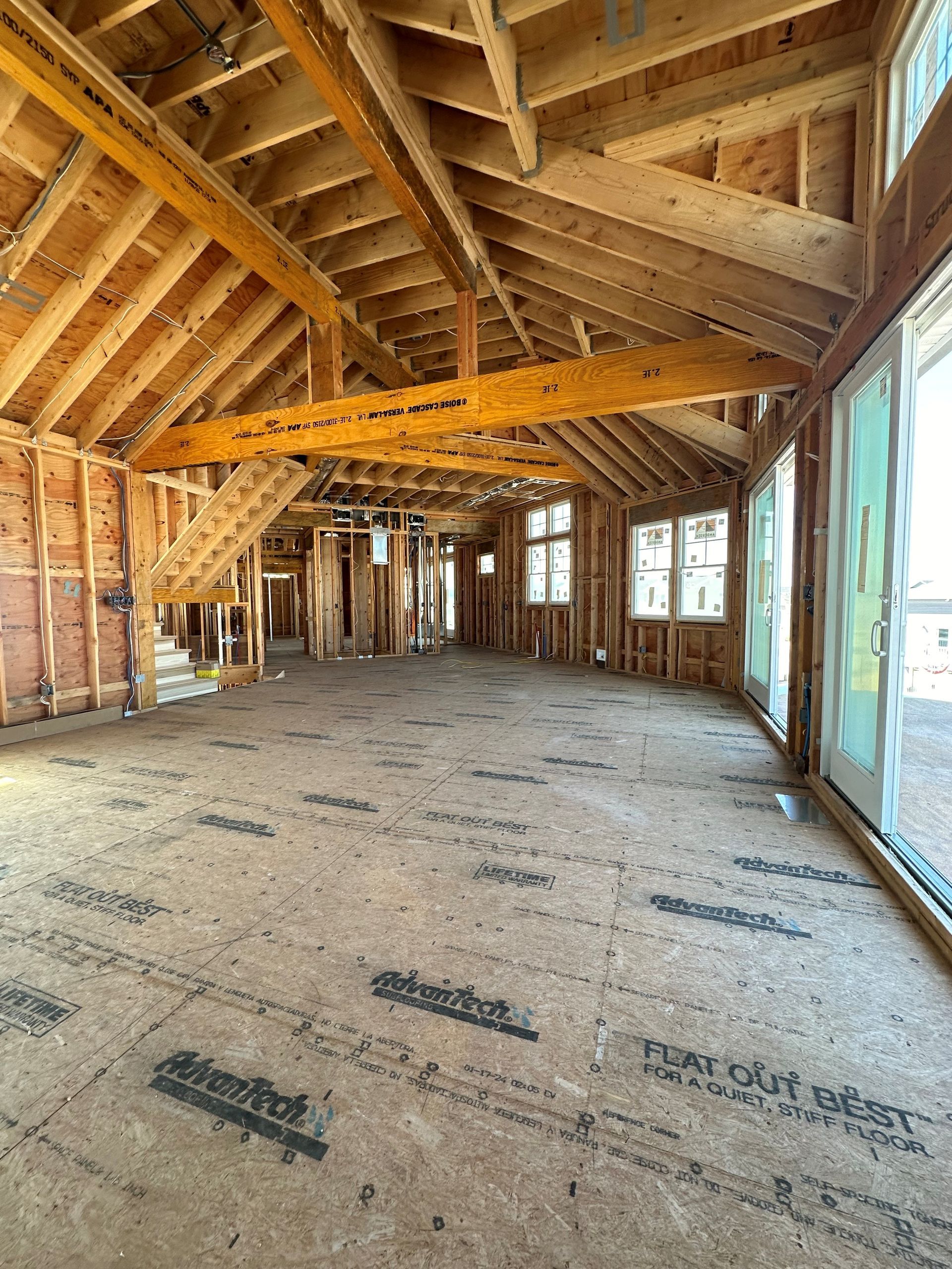 A large room with a lot of windows and wooden beams.