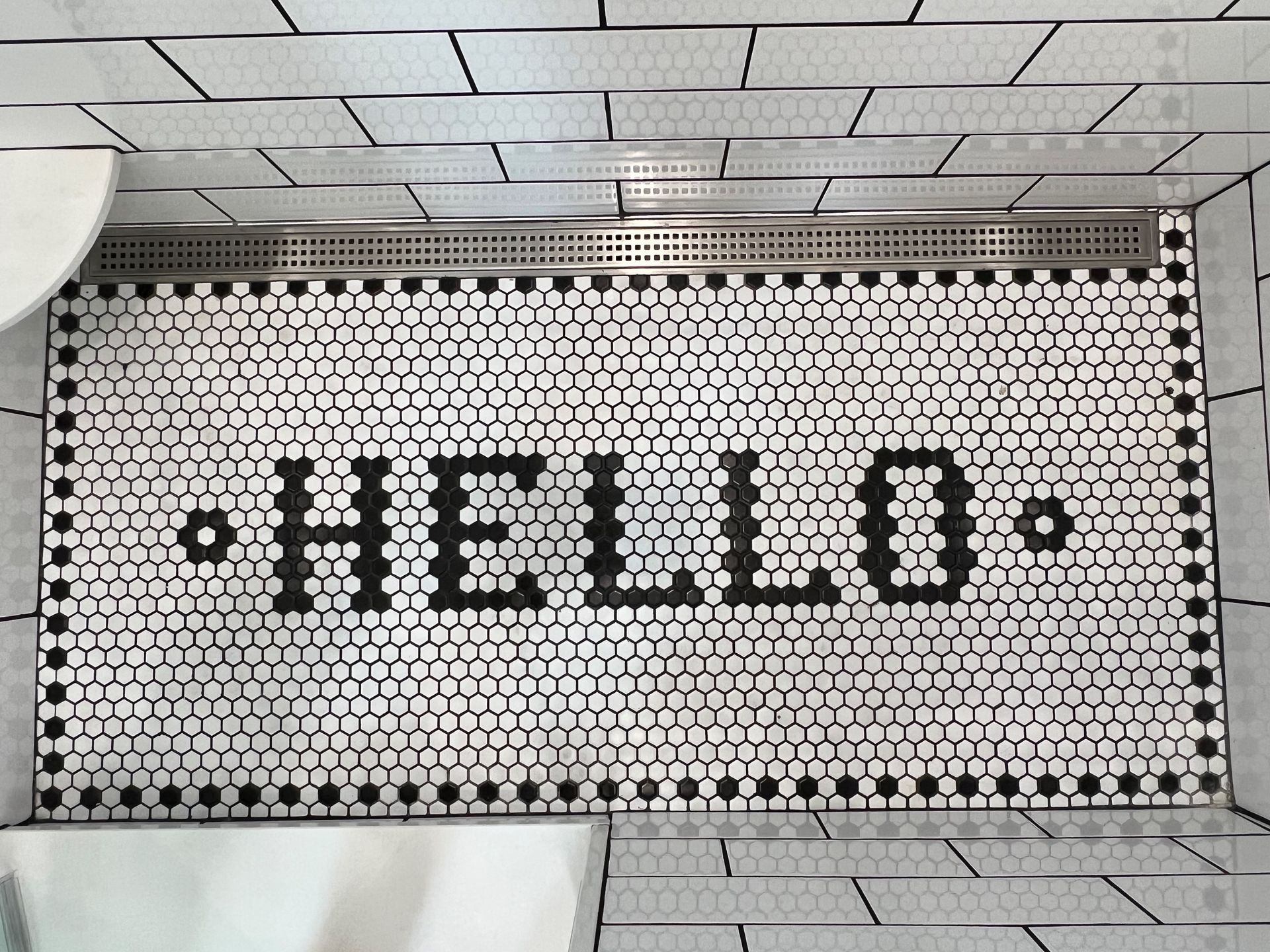 A black and white tile floor with the word hello written on it.