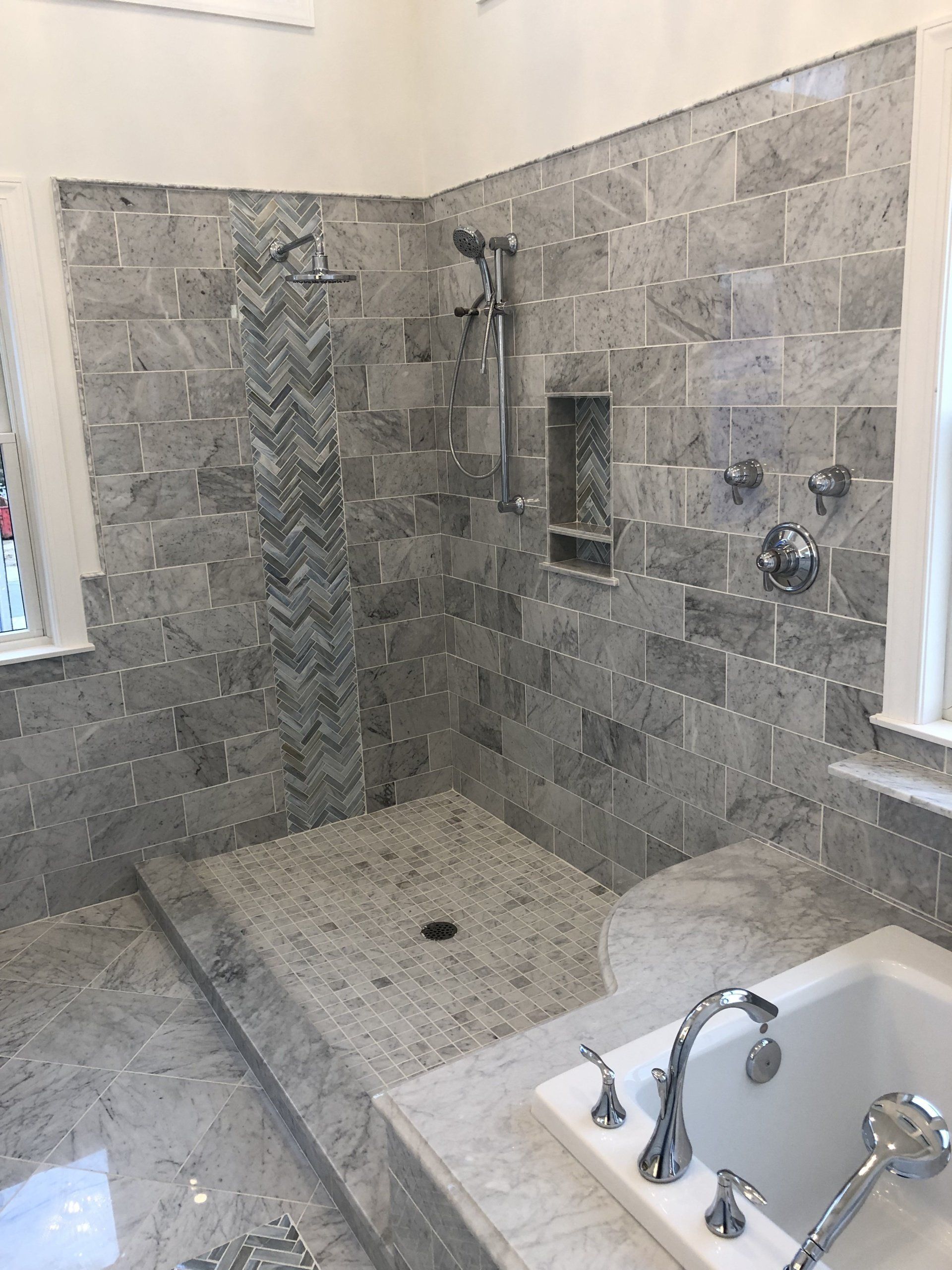 A bathroom with a walk in shower and a bathtub.