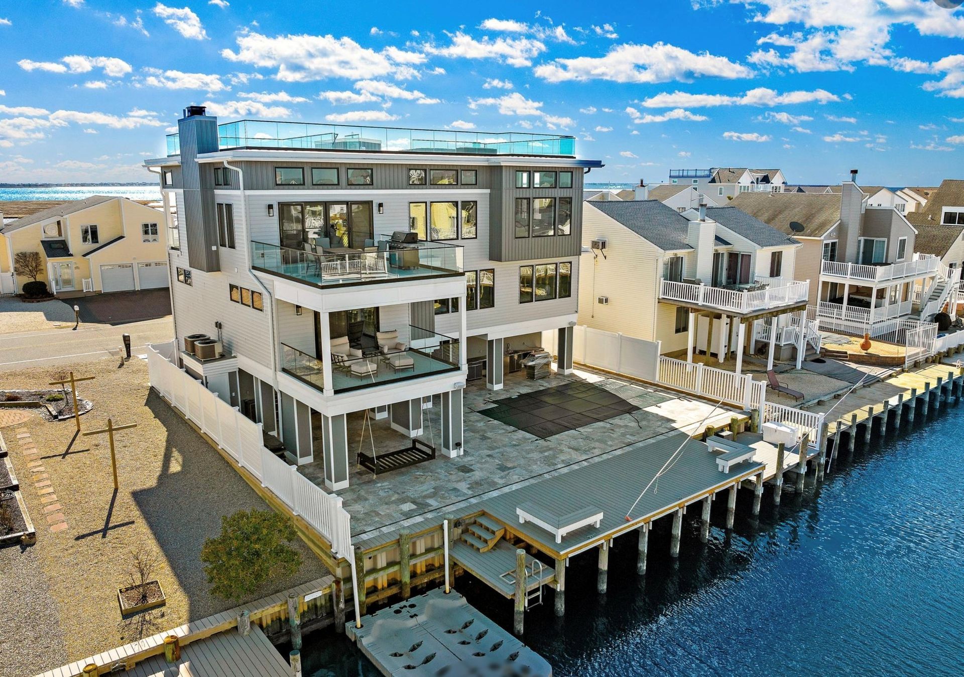 An aerial view of a large house next to a body of water