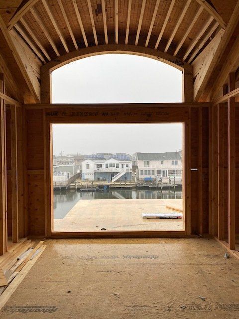 A large window in a building with a view of a body of water