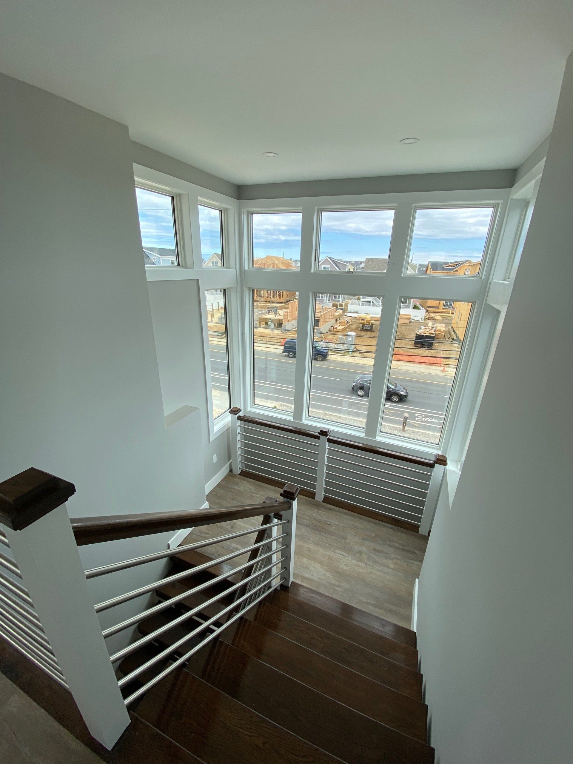A view of a staircase from the second floor of a house.