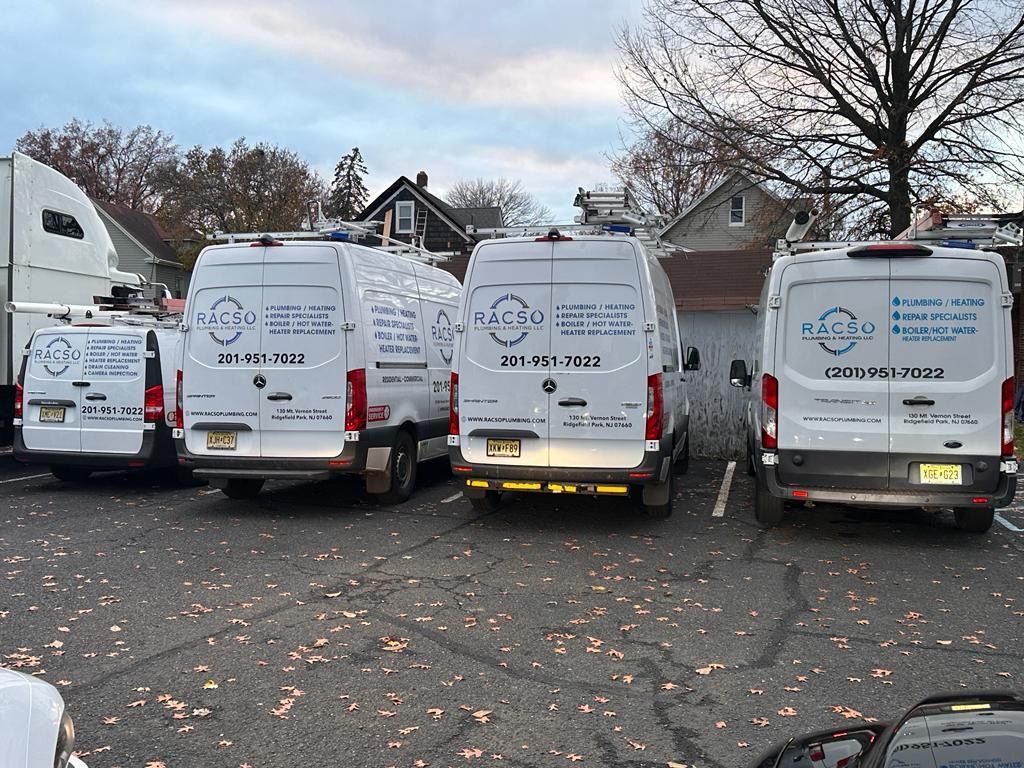 A row of vans are parked in a parking lot.
