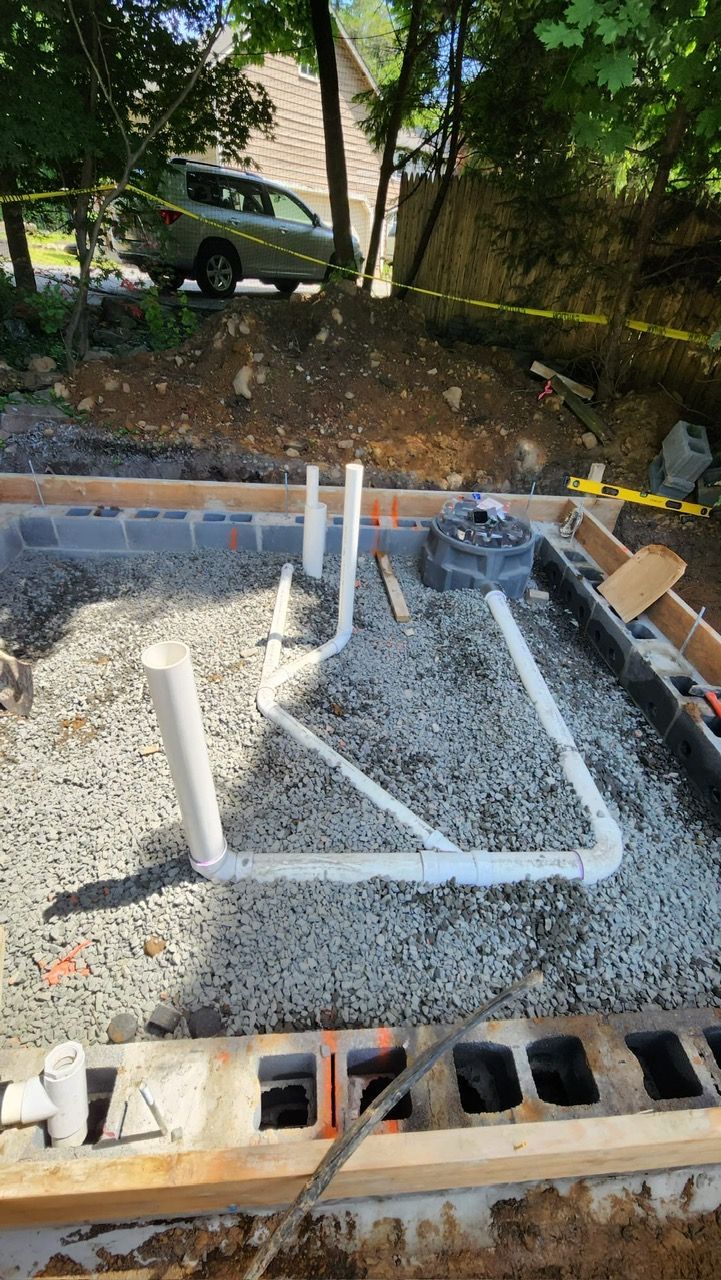 A car is parked in the background of a construction site