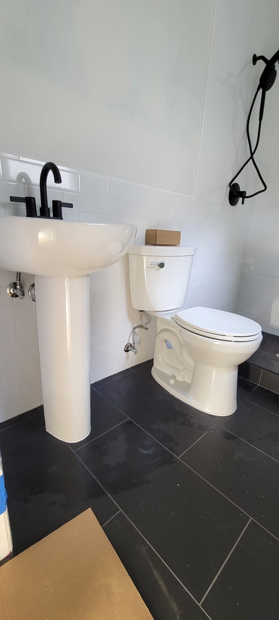 A bathroom with a sink, toilet, and shower