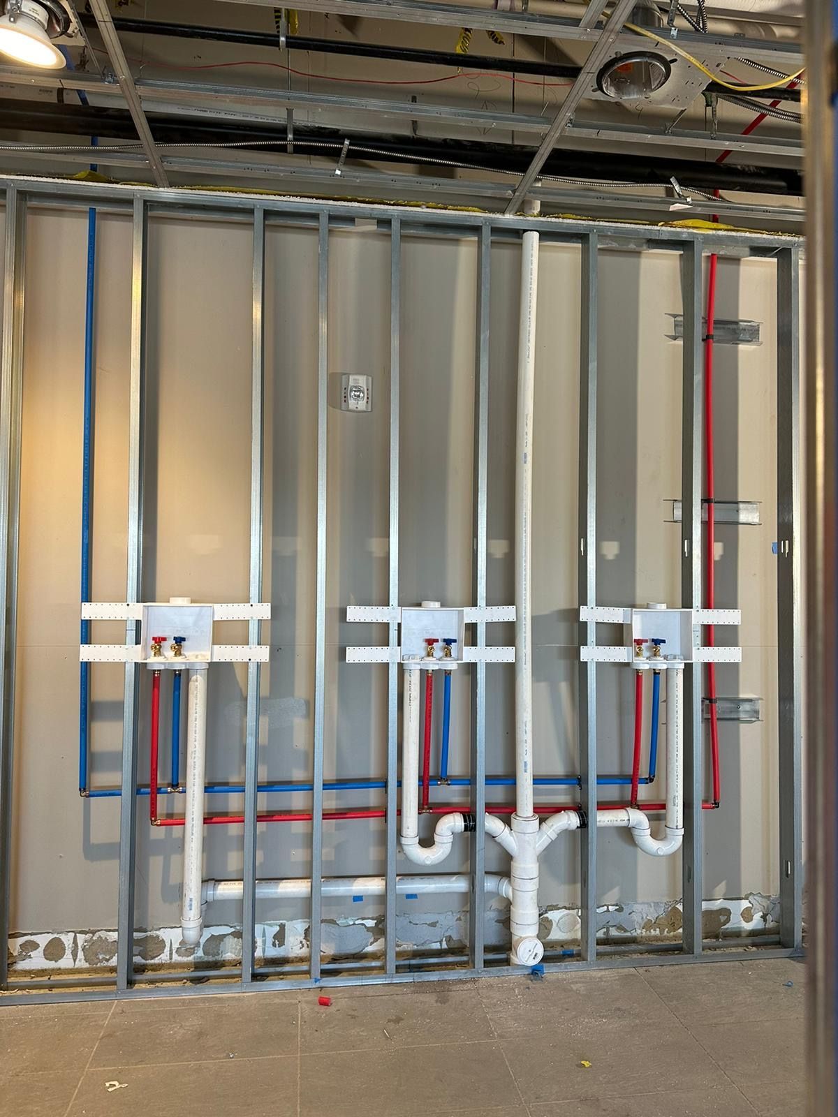 A wall with a lot of pipes on it