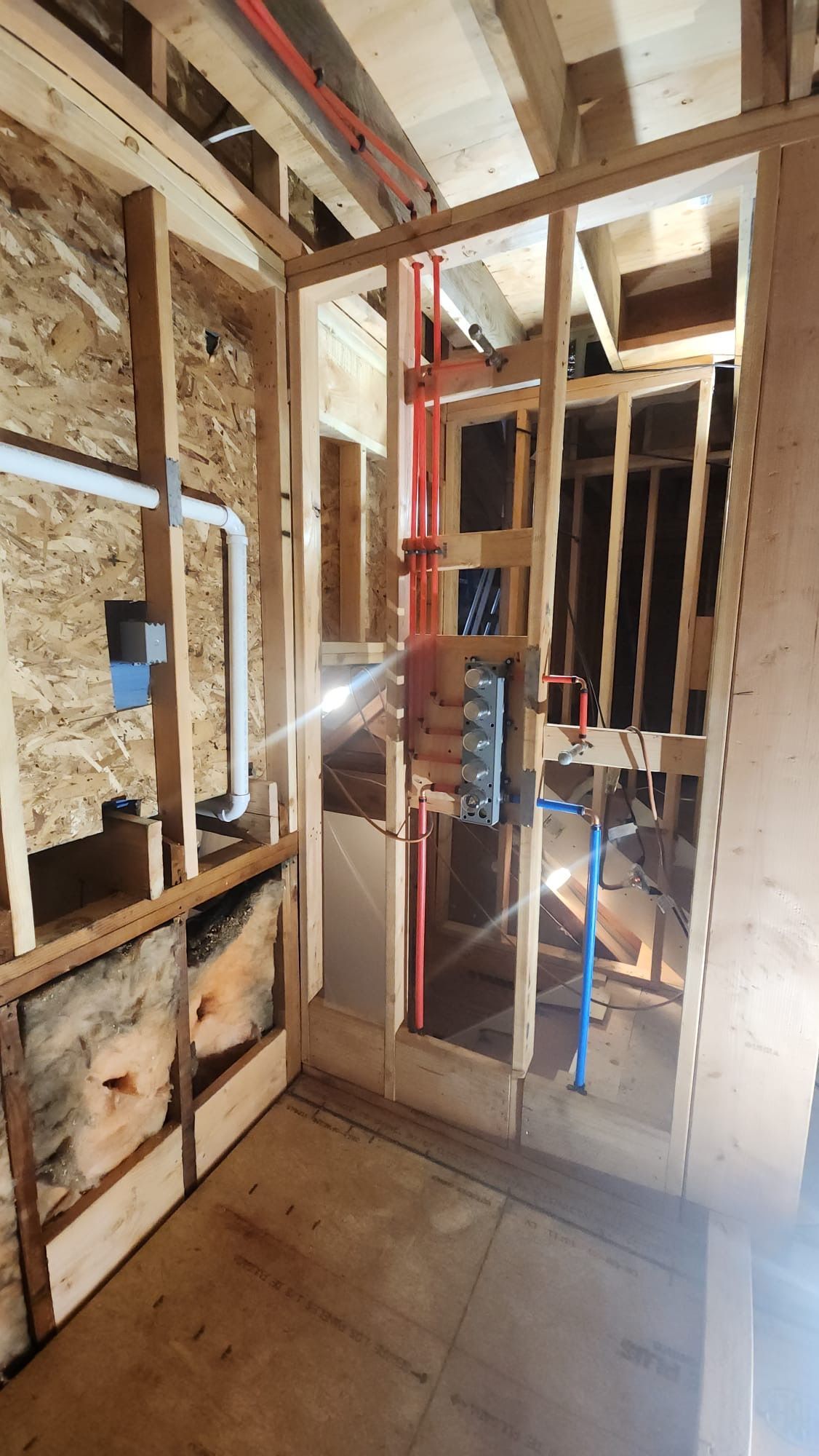 Installed plumbing pipes in a room under construction