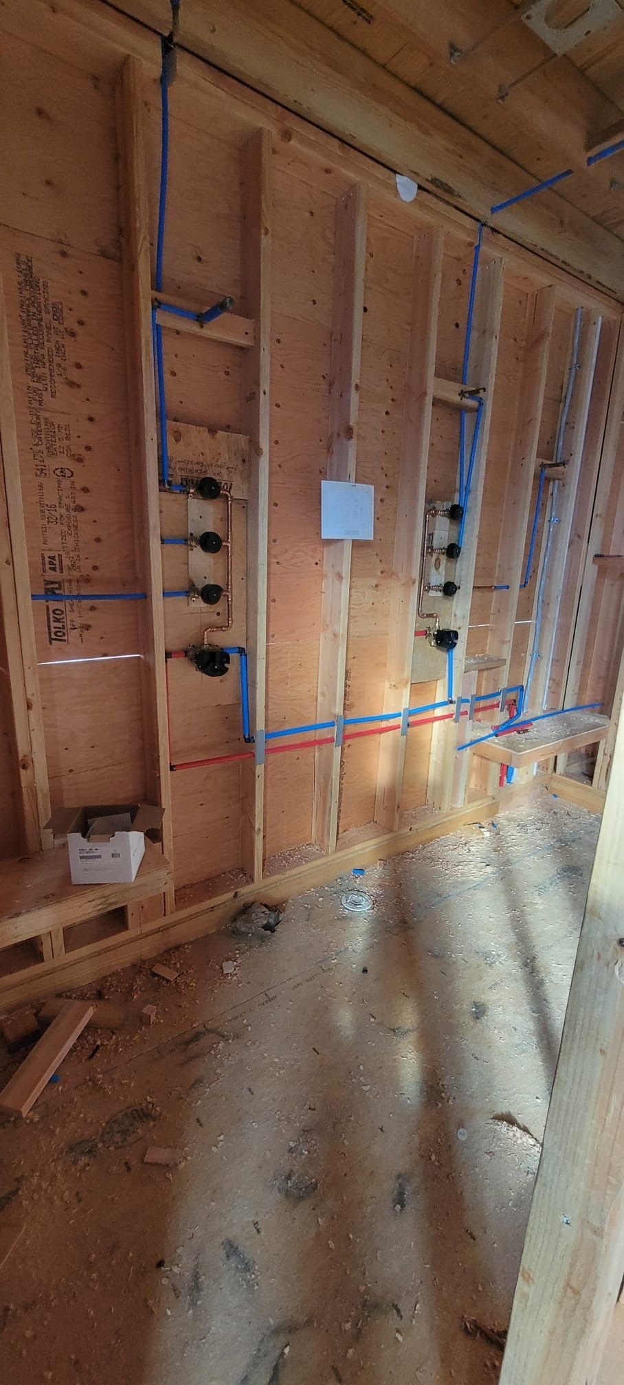 A room under construction with plumbing pipes installed