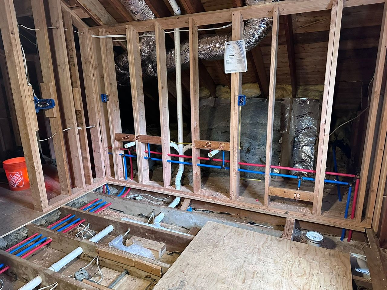 A room with a wooden frame and pipes in it