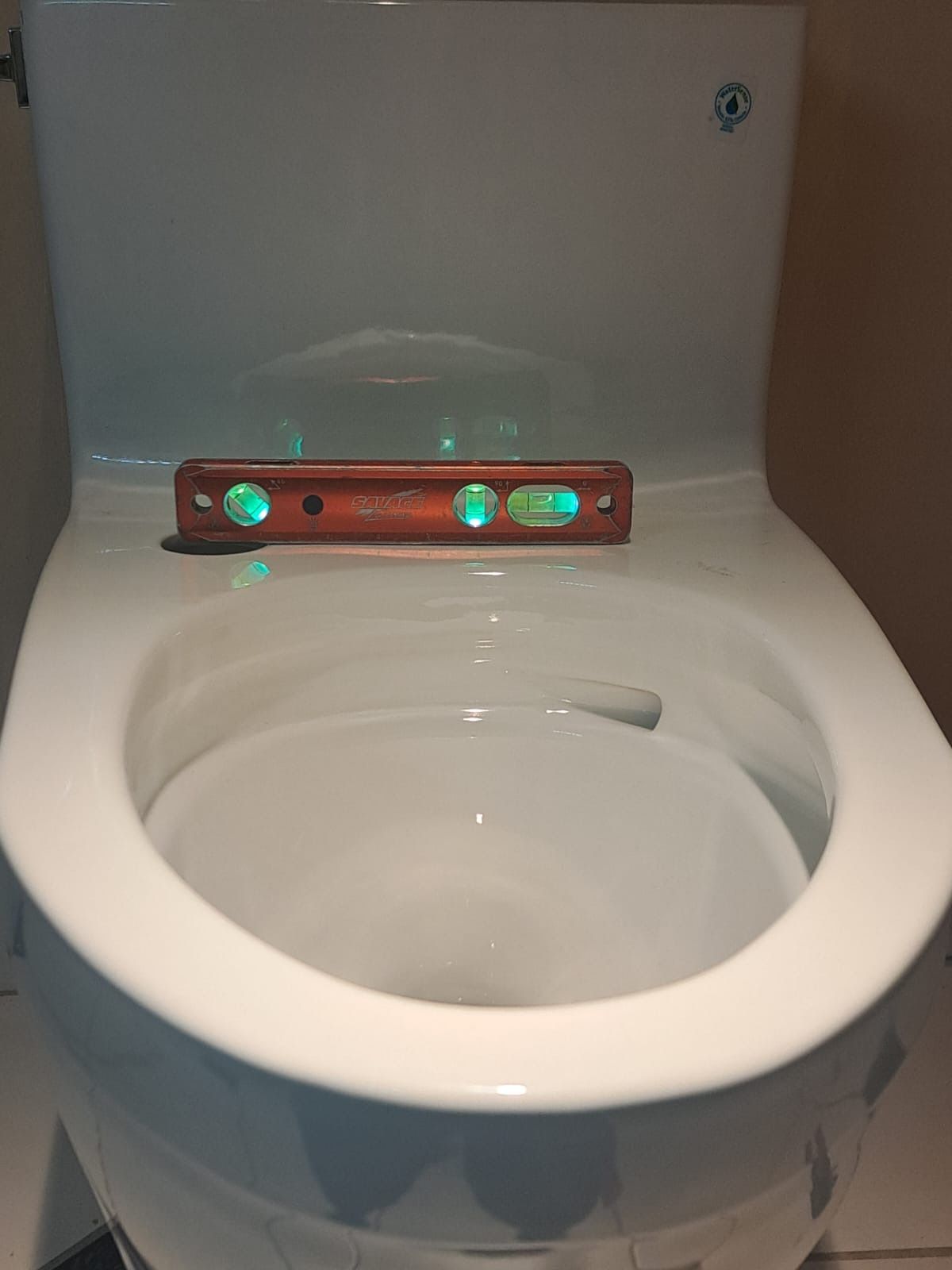 A toilet with a level on top of it