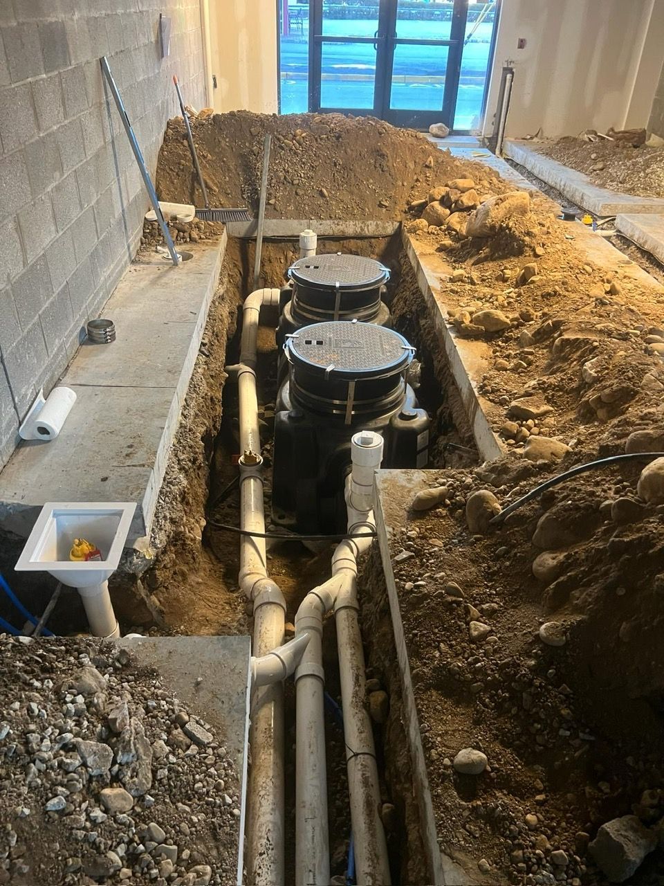 A bunch of pipes are being installed in a hole in the ground