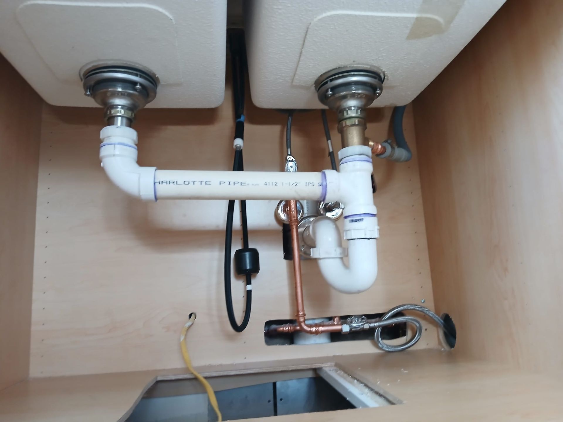 A bathroom sink with a white pipe