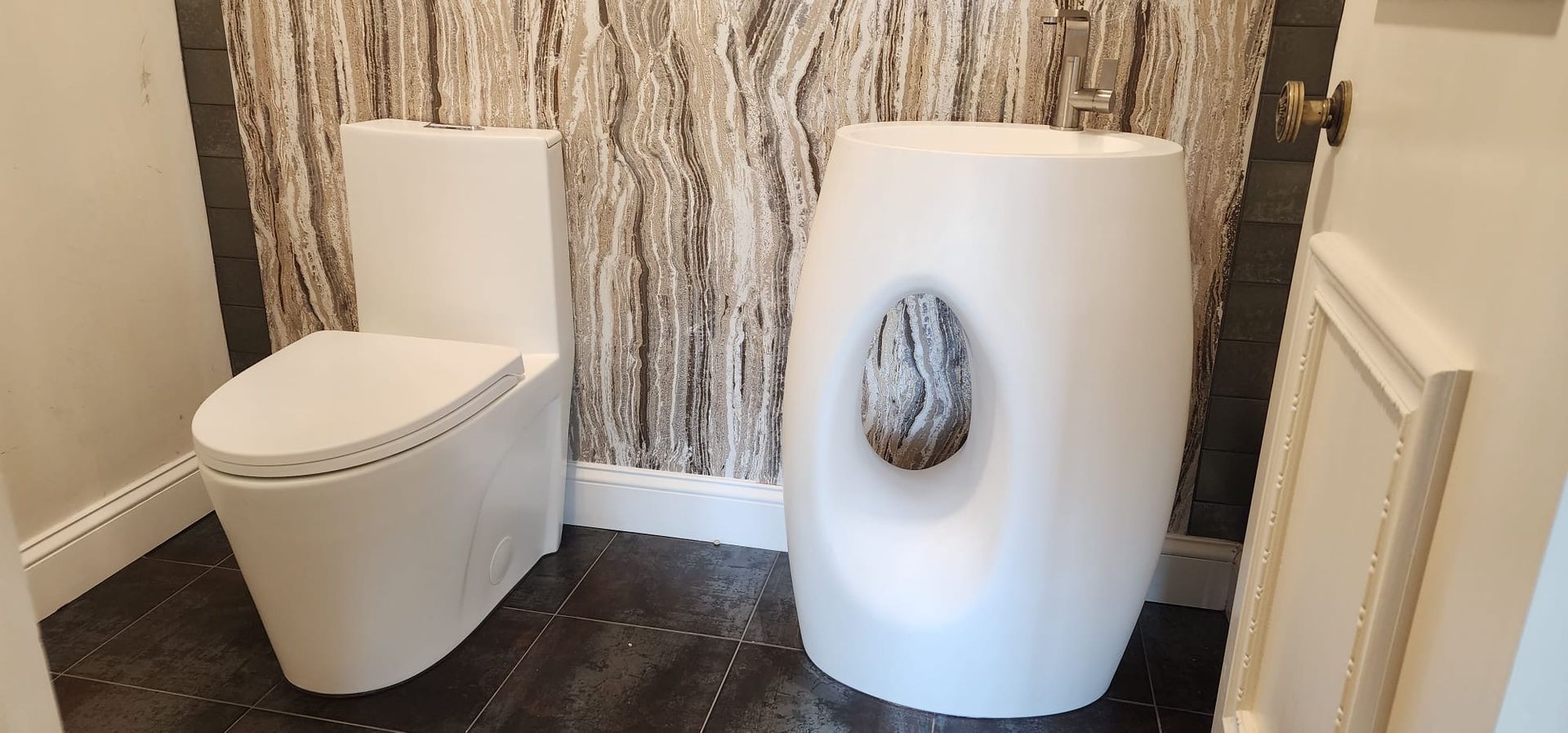 There is a toilet and a sink in the bathroom