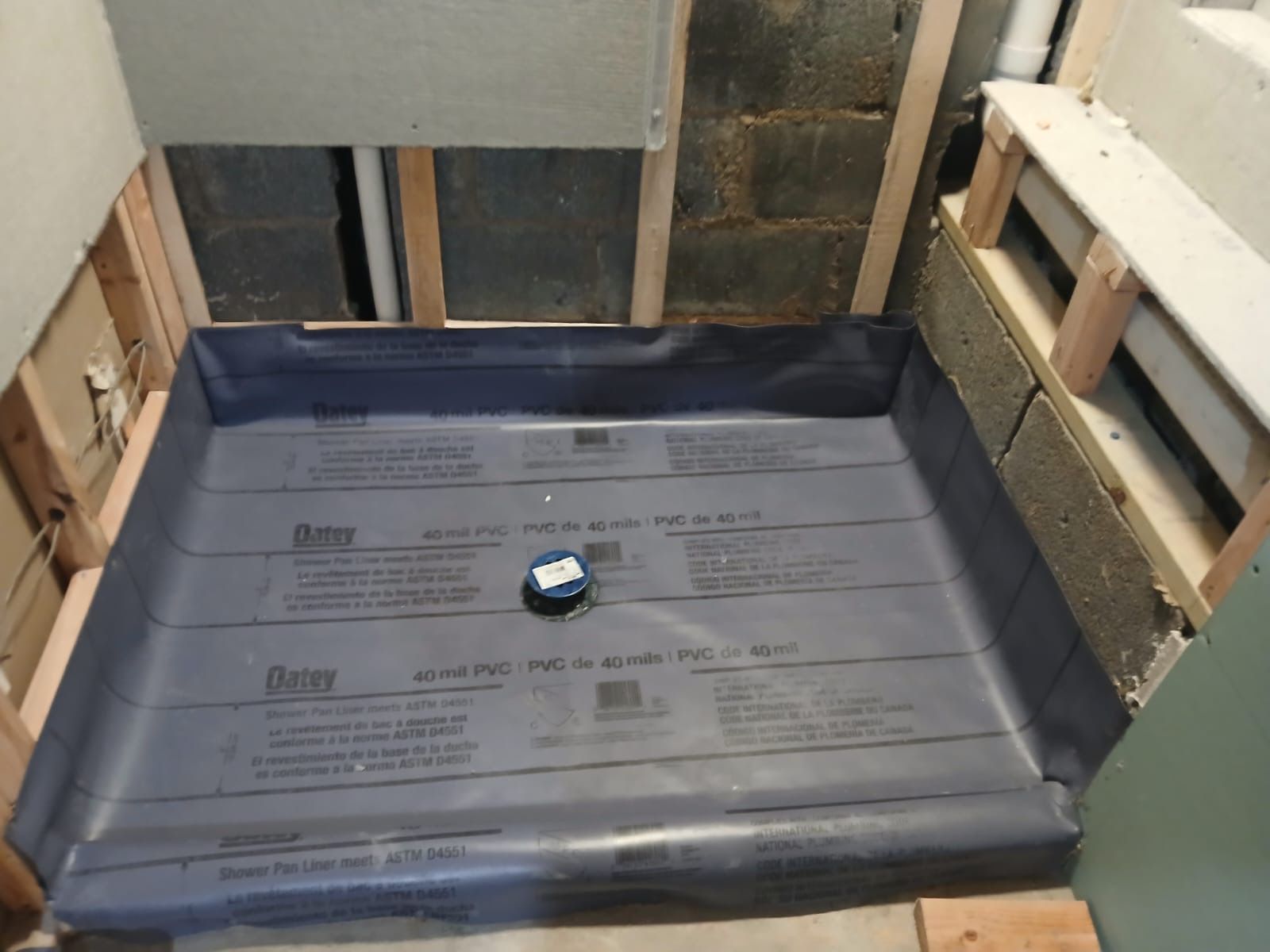 A shower stall is being built in a bathroom