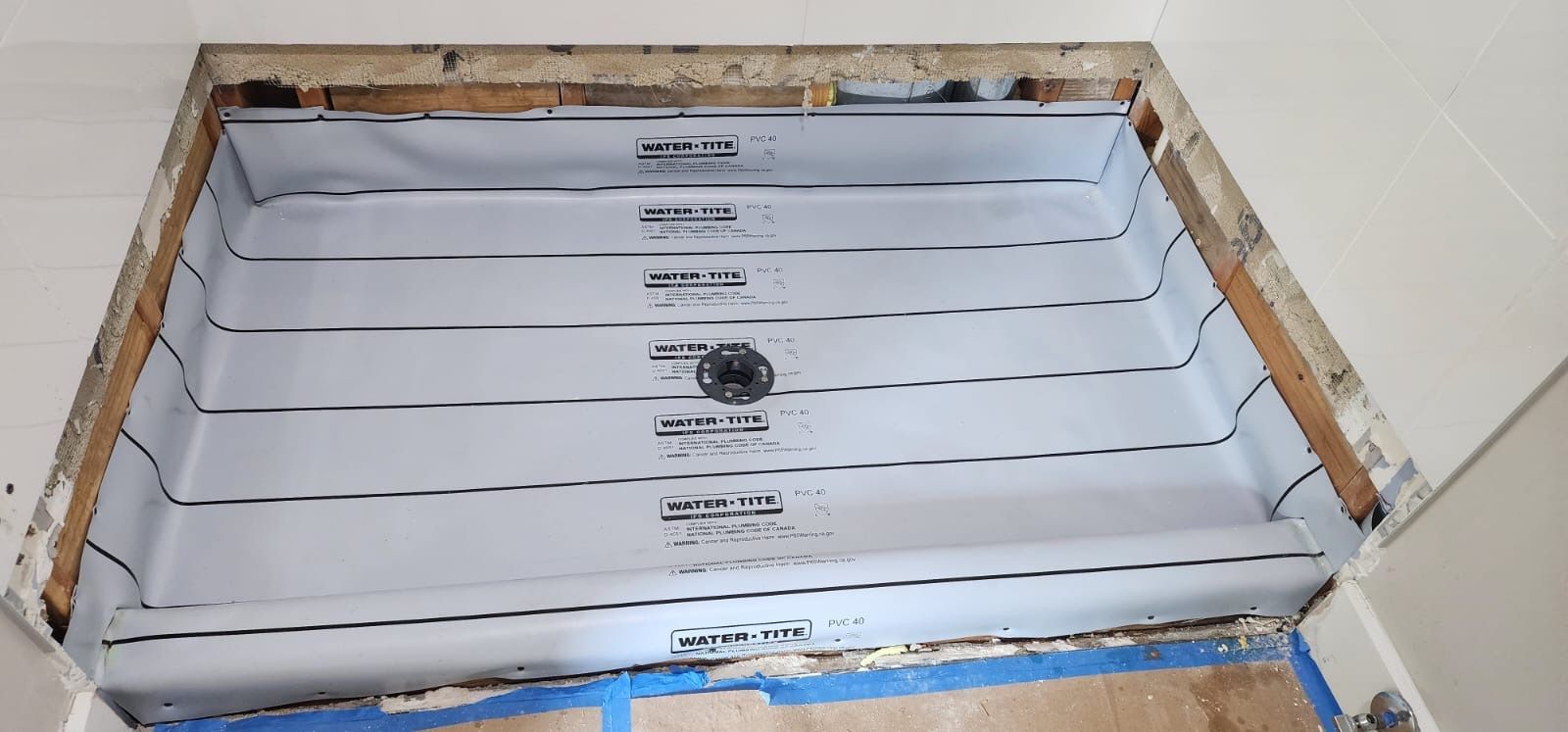 A shower stall is being installed in a bathroom