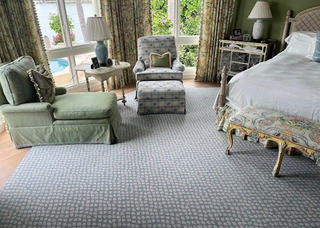 A bedroom with a bed , chairs , ottoman and bench.