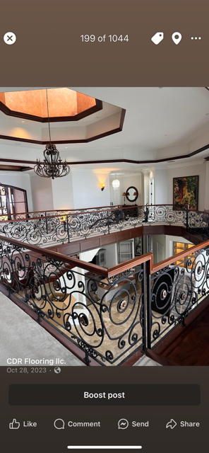 A phone screen shows a staircase with a wrought iron railing