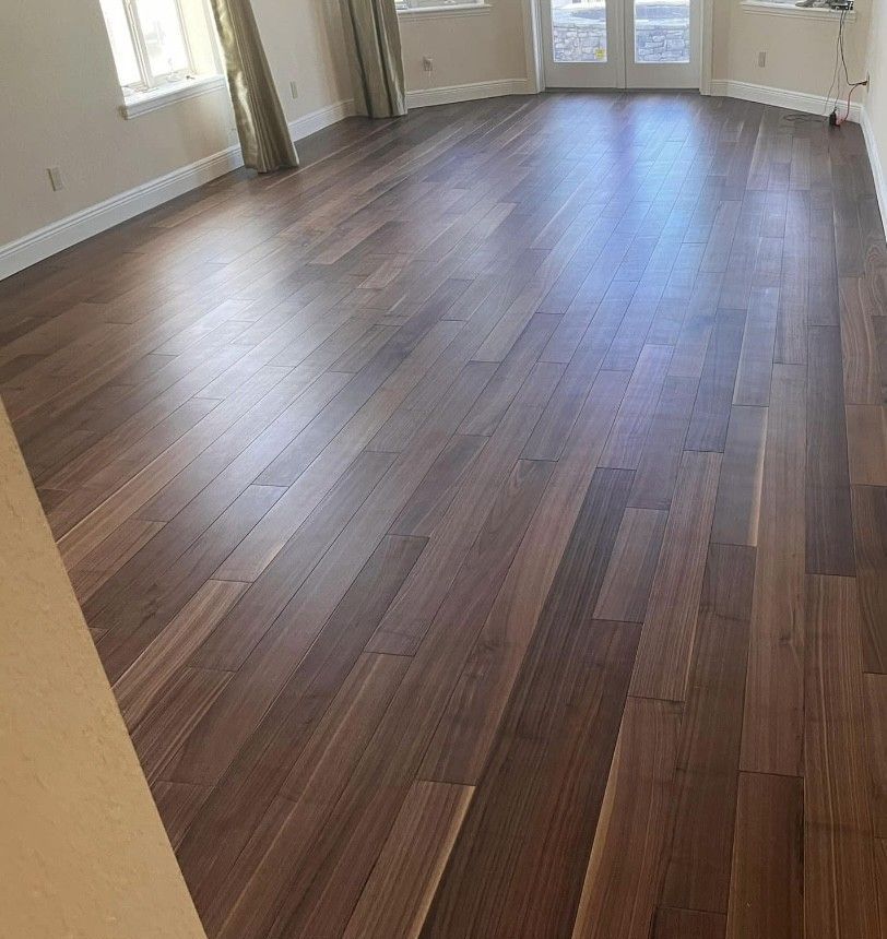 A living room with hardwood floors and a sliding glass door.