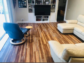 A living room with a couch , chair , and television.