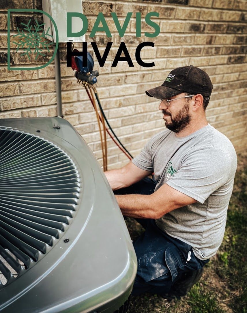 HVAC technician works on an outdoor air conditioning unit. Davis HVAC logo in the top left.