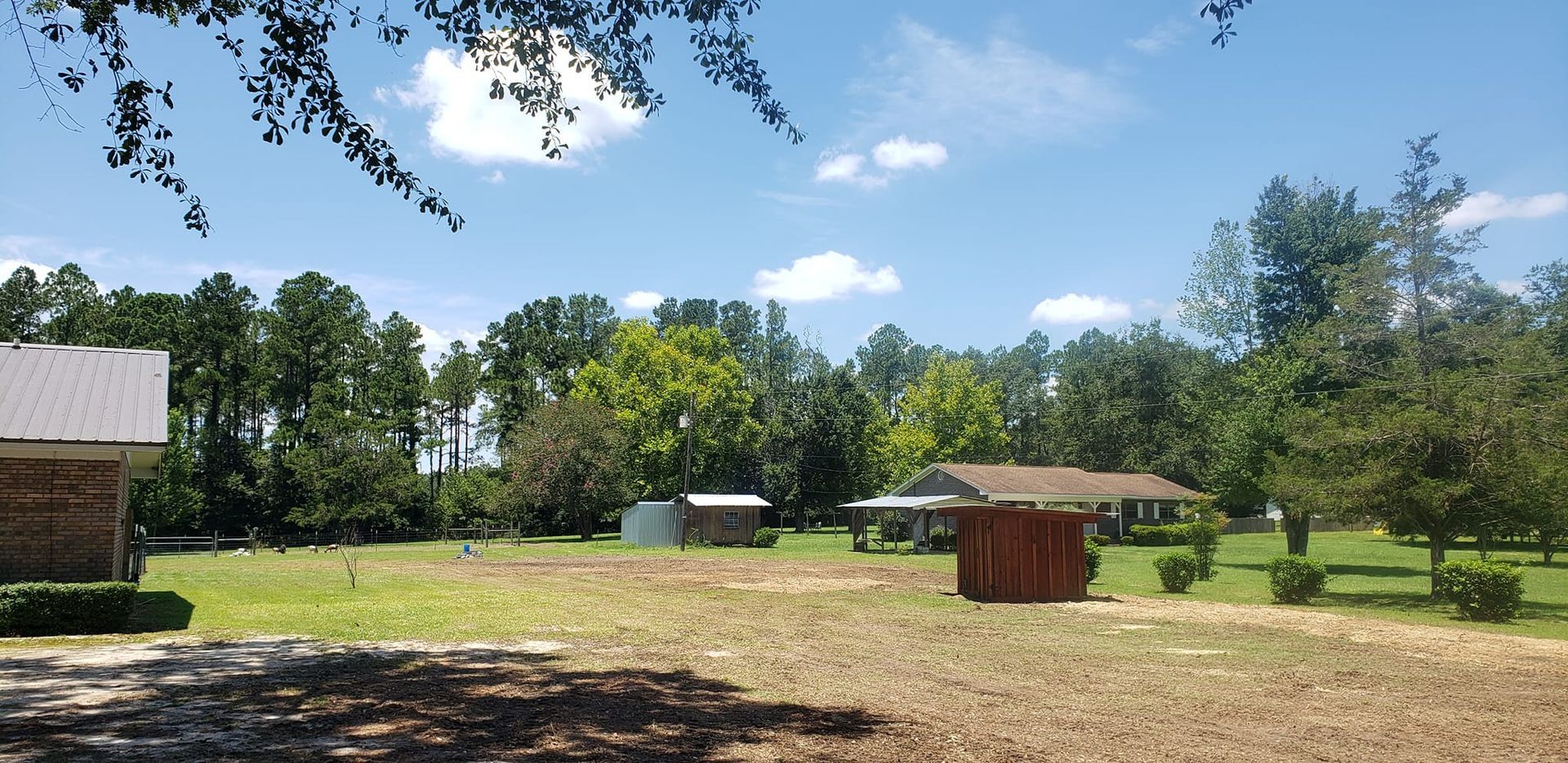 A house sits in the middle of a lush green field