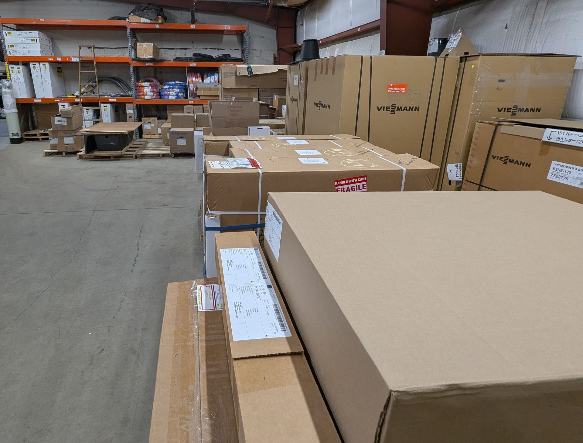 A large warehouse filled with lots of cardboard boxes