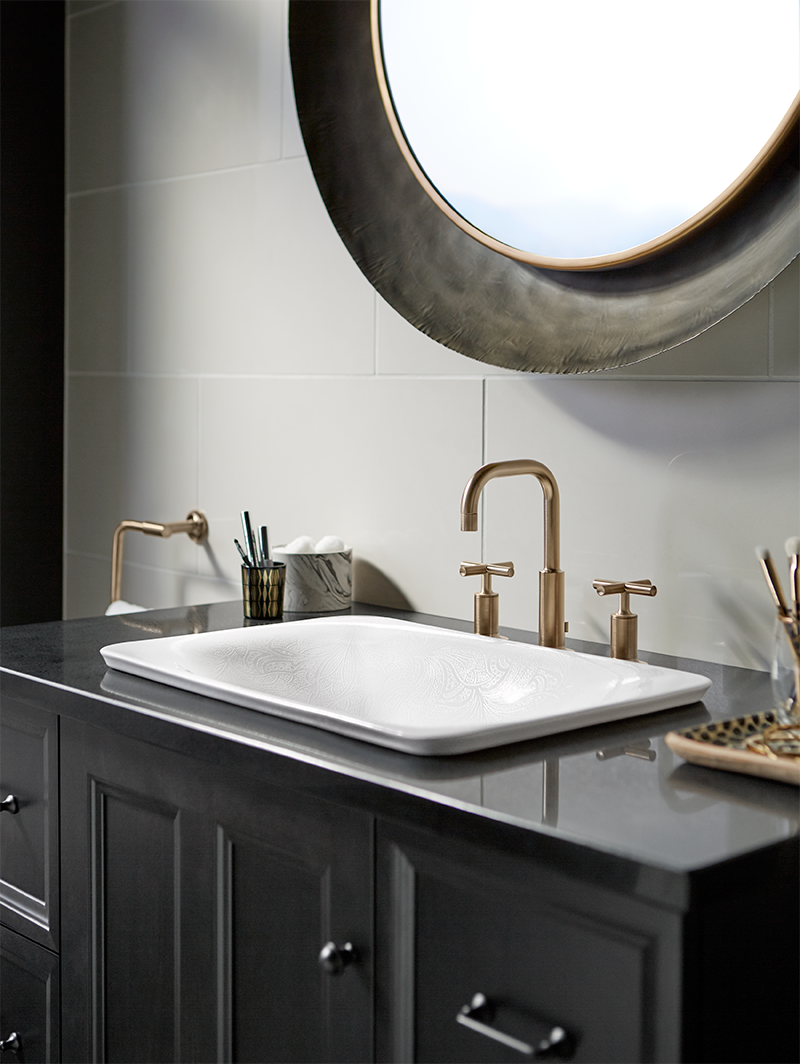 A bathroom vanity with a sink and a mirror.