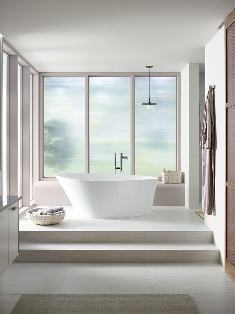 A bathroom with a large tub and a large window.