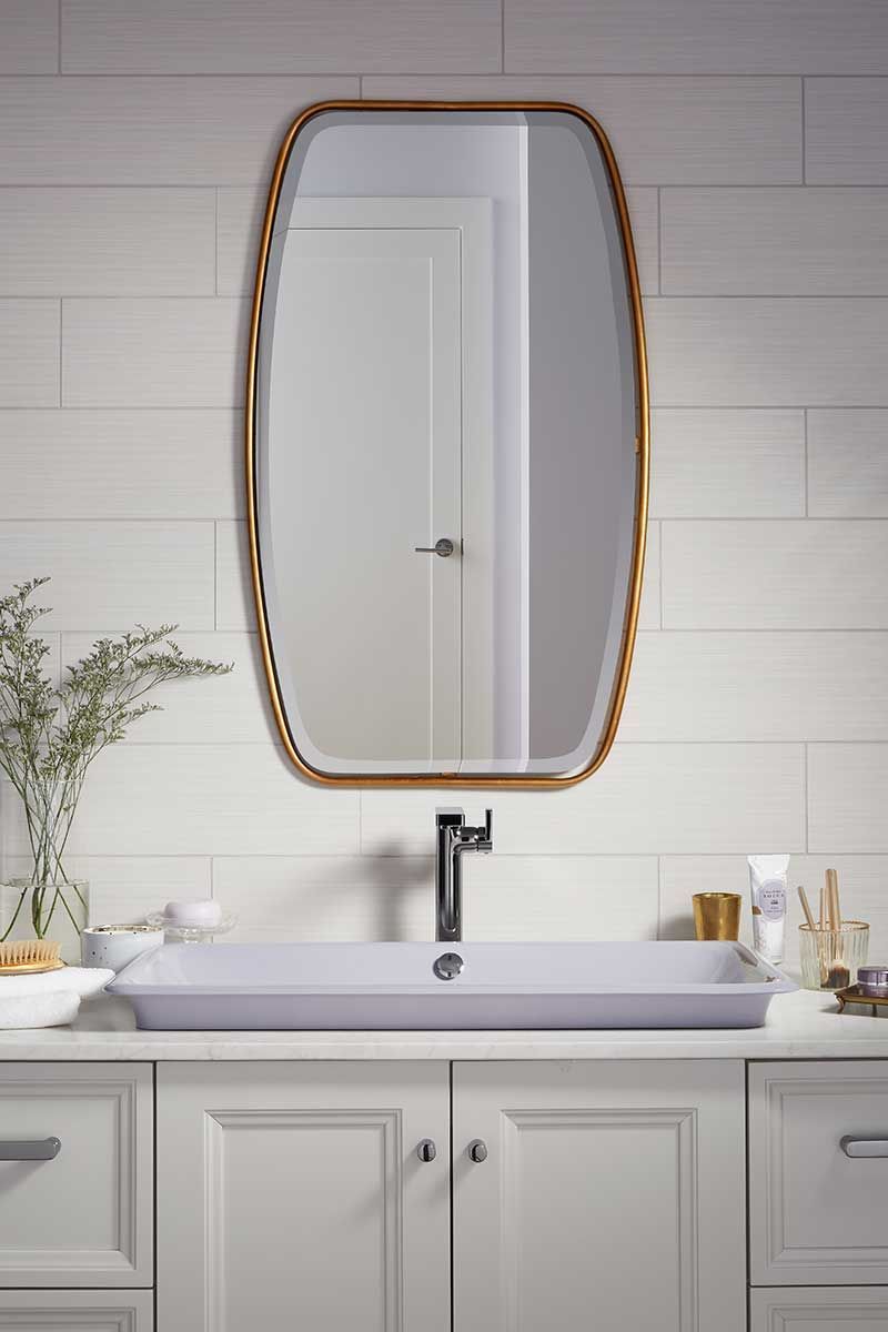 A bathroom with a sink and a mirror on the wall.