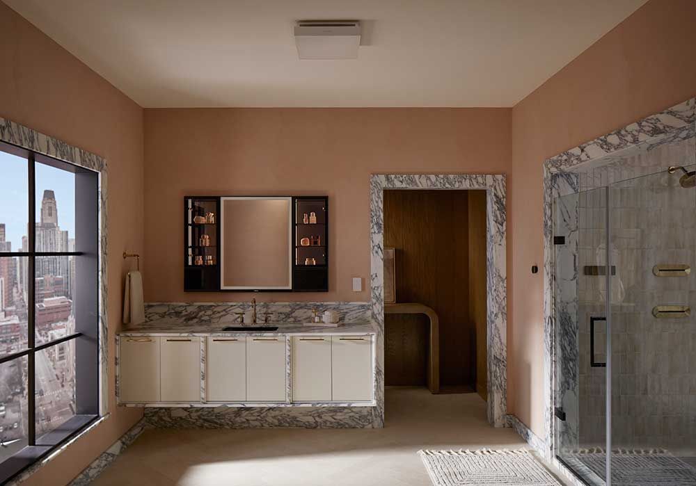 A bathroom with a sink a mirror and a walk in shower