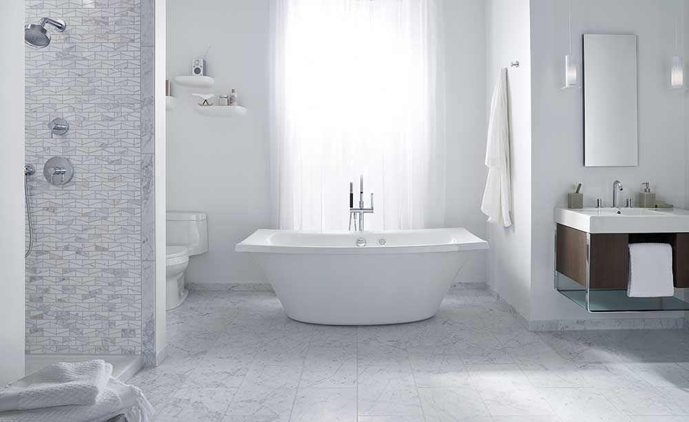 A bathroom with a tub , sink , toilet and shower.