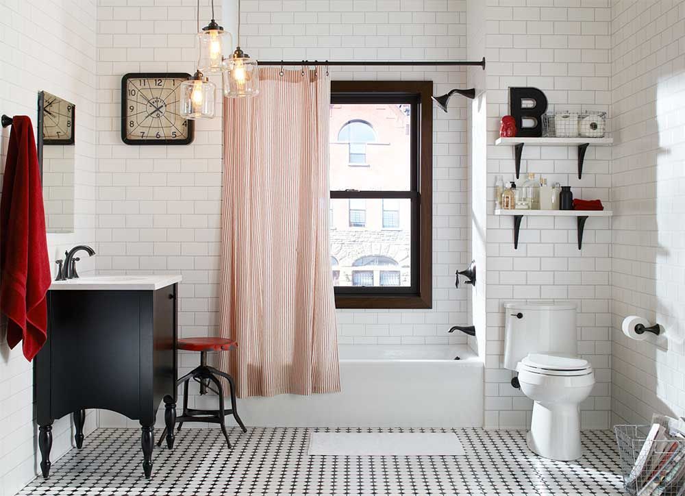A bathroom with a toilet a sink and a window