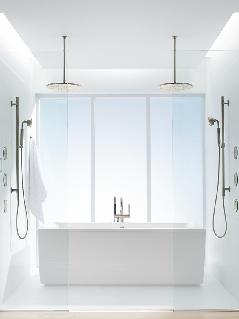 A bathroom with a bathtub and two showers.
