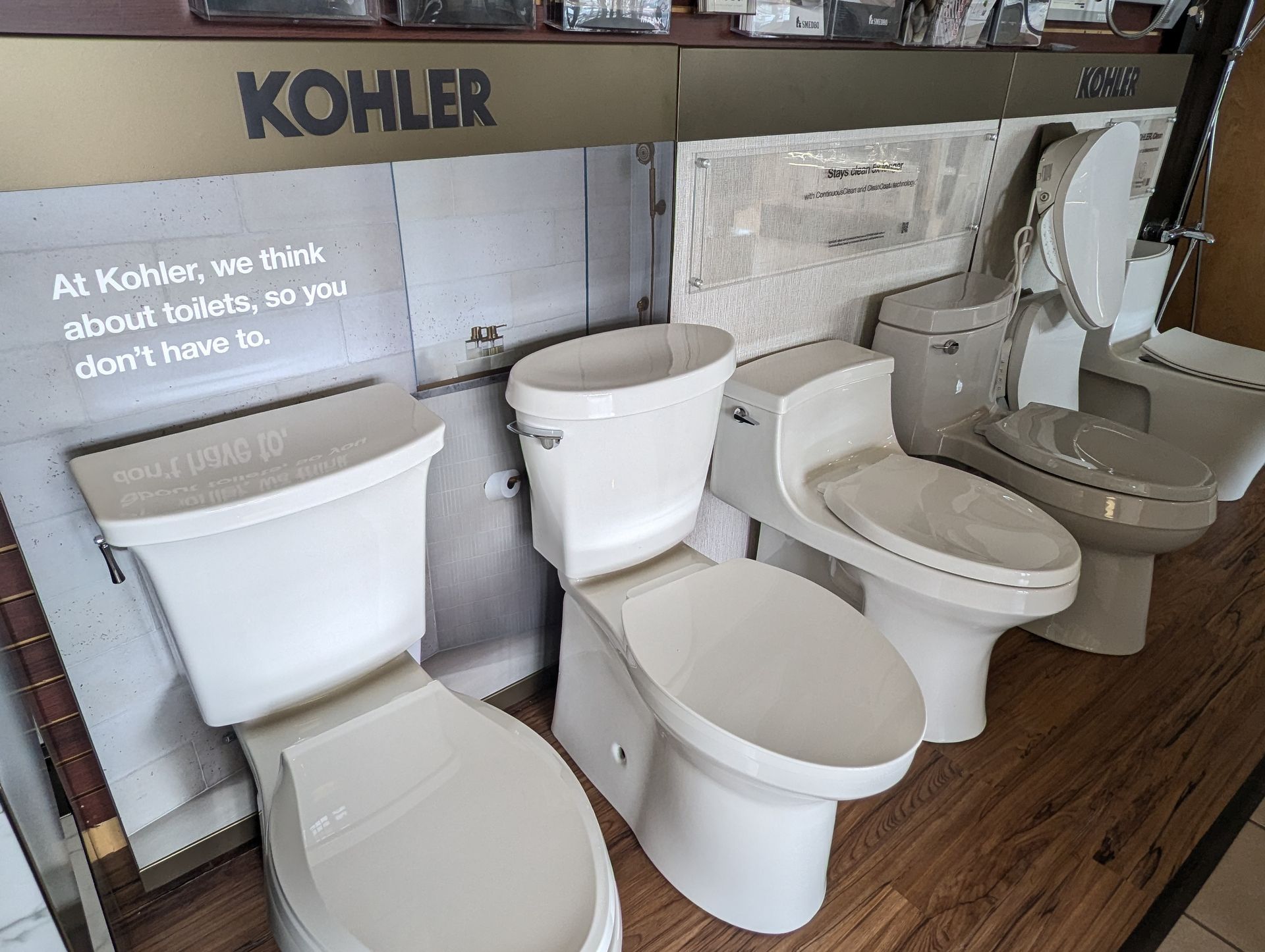There are many different types of toilets on display in a store.