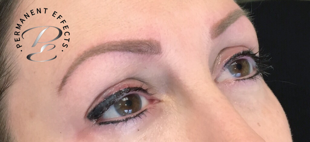 A close up of a woman's face with a tattoo on her forehead.