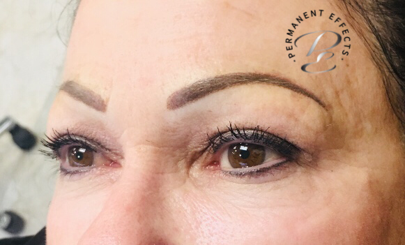 A close up of a woman's face with permanent eyebrows.