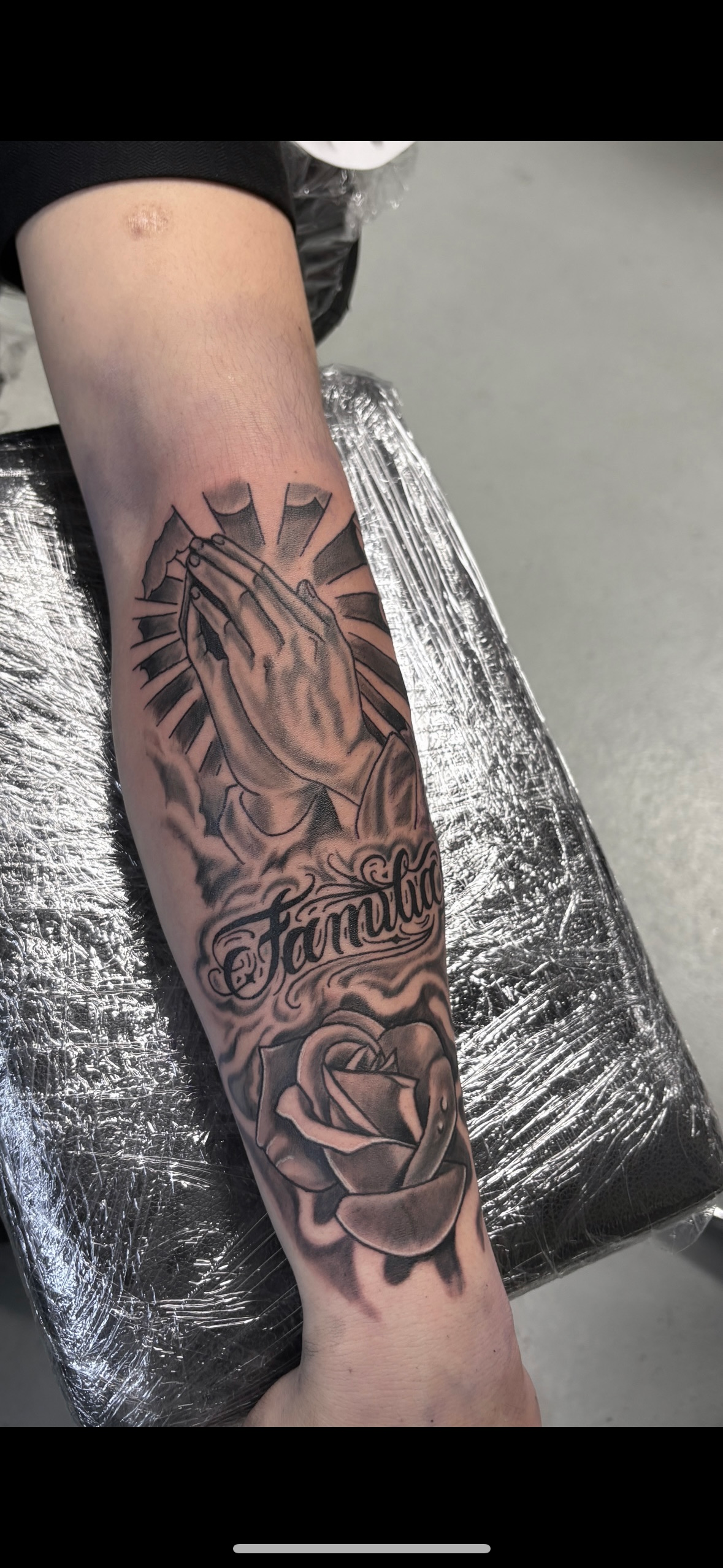 A person is getting a tattoo on their leg.