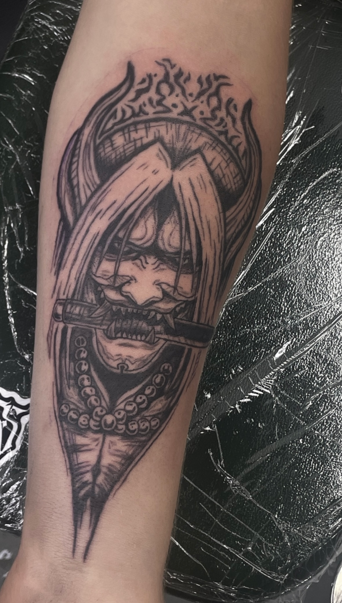 A person has a tattoo of a viking on their arm