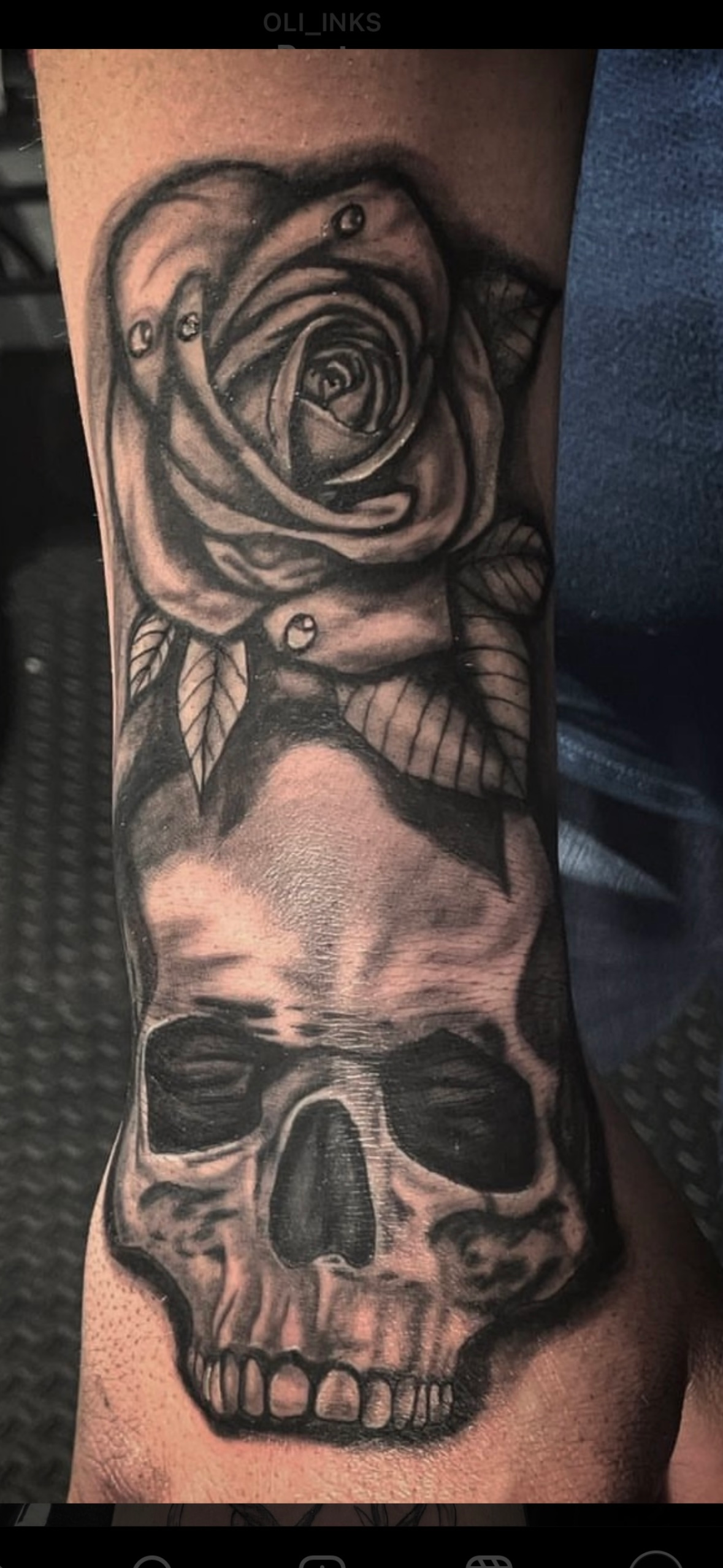 A tattoo of the aurora borealis over a forest on a persons forearm