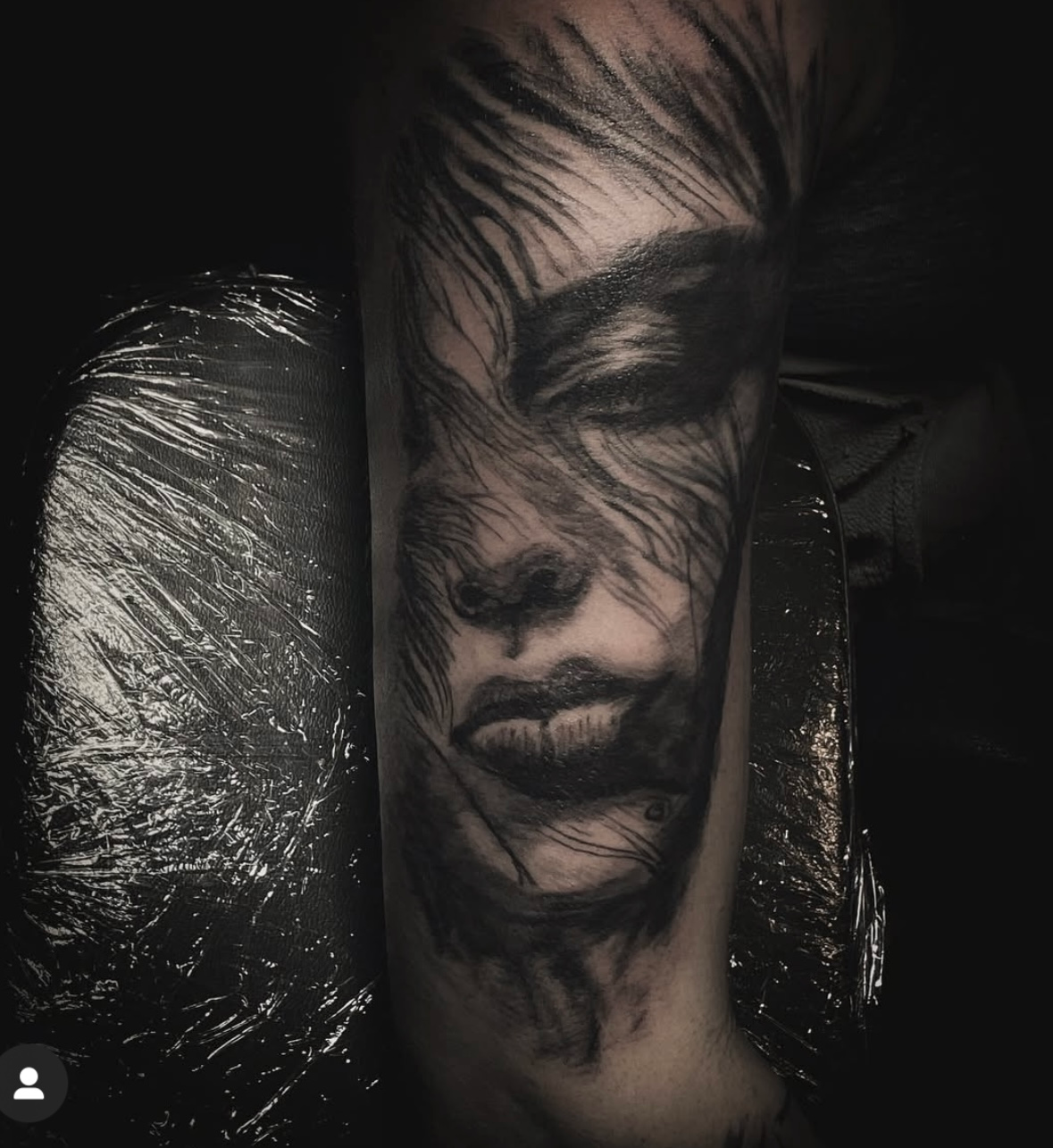 A woman has a tattoo of flowers and butterflies on her forearm