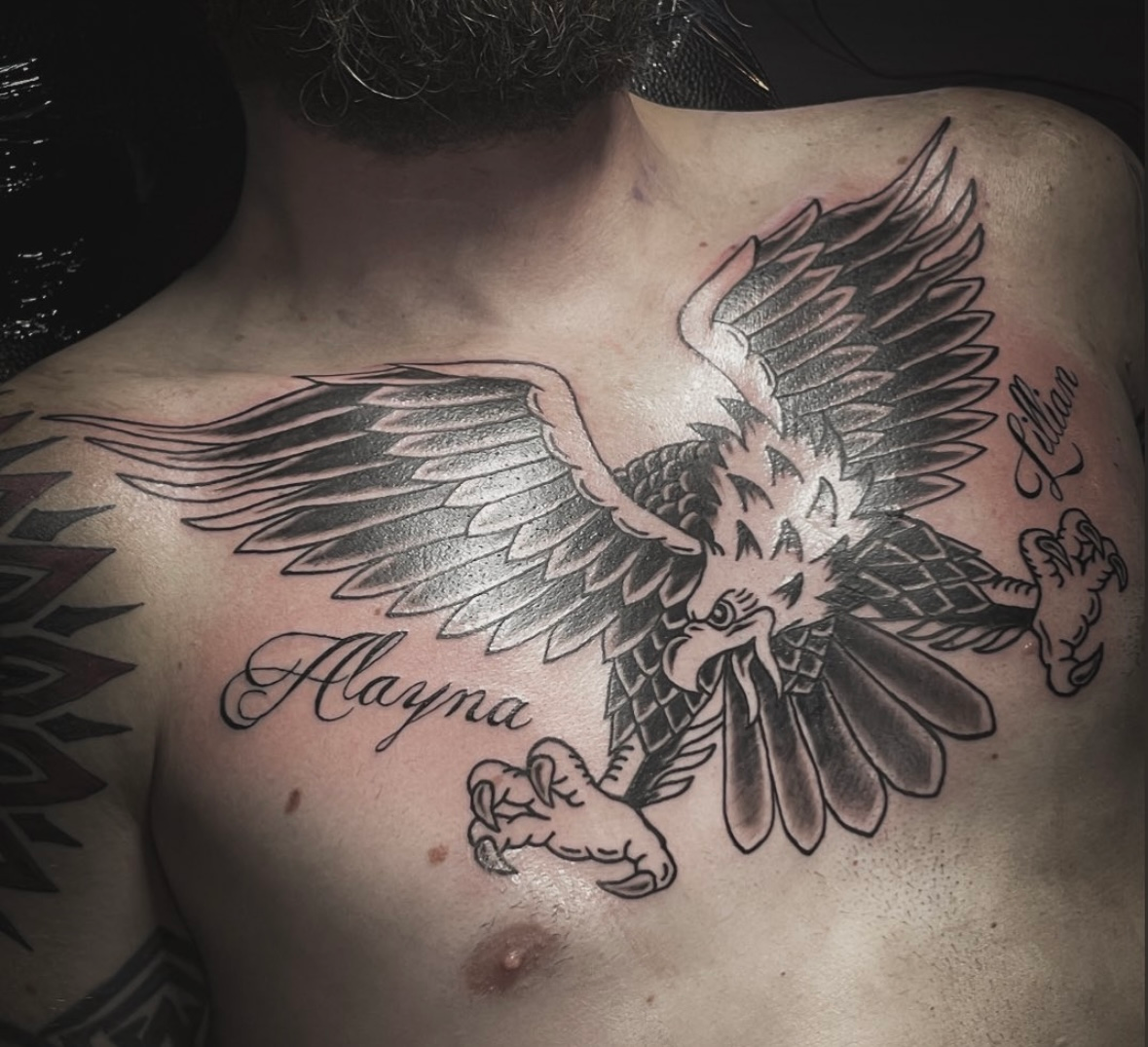 A black and white butterfly tattoo on a womans leg