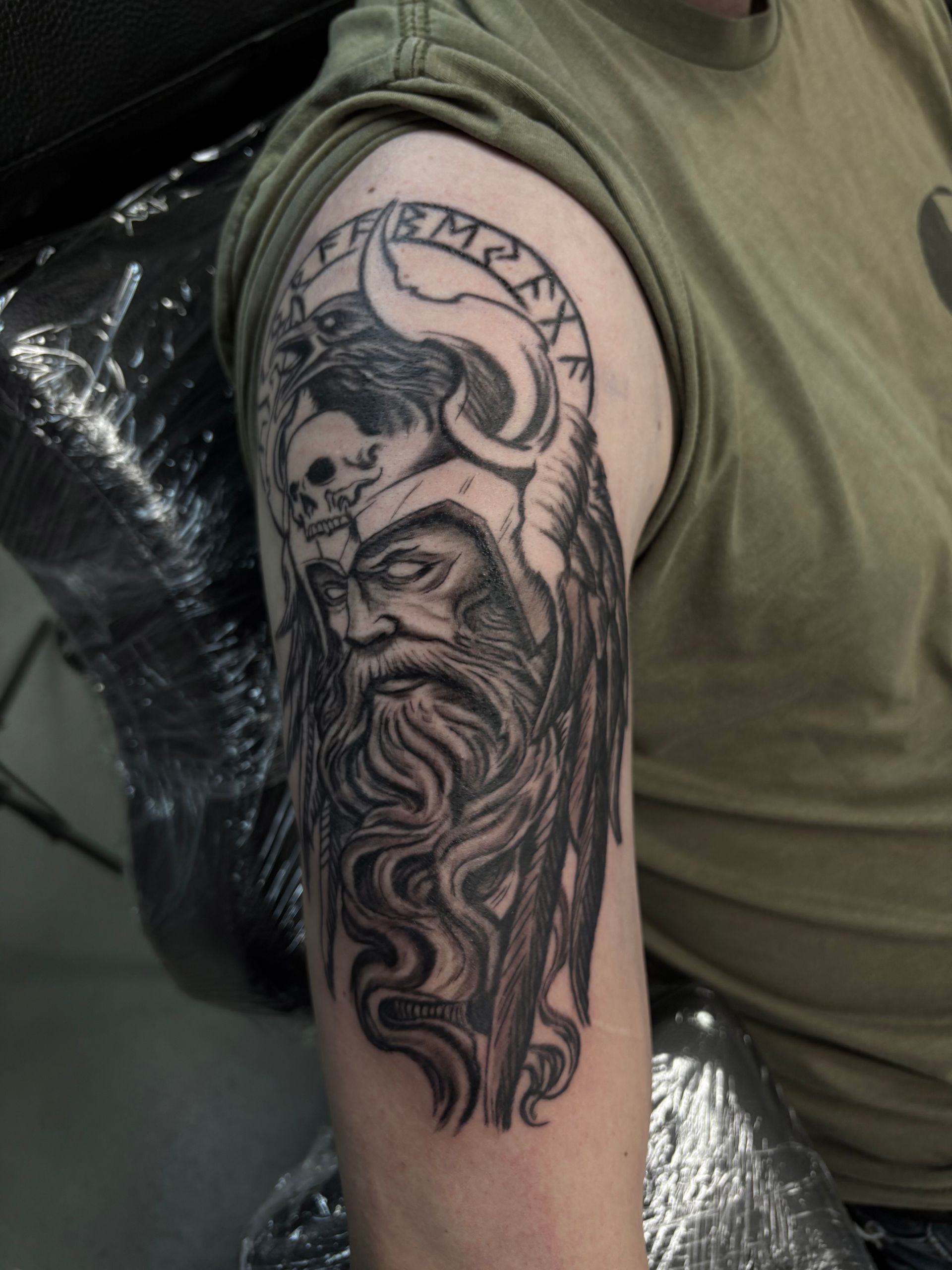 A man has a tattoo of a viking on his arm