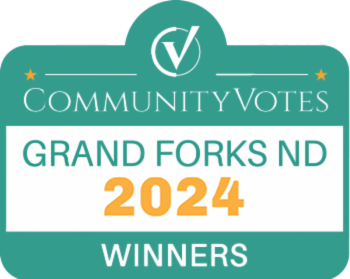 A green sign that says community votes grand forks 2024 winners