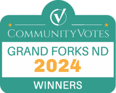 A green sign that says community votes grand forks 2024 winners