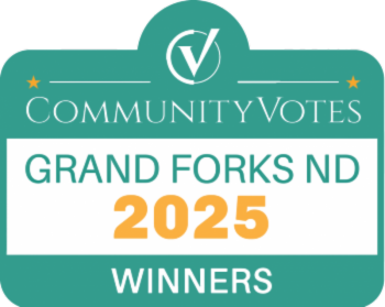 A green sign that says community votes grand forks 2025 winners