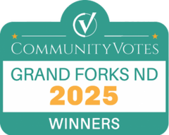 A green sign that says community votes grand forks 2025 winners