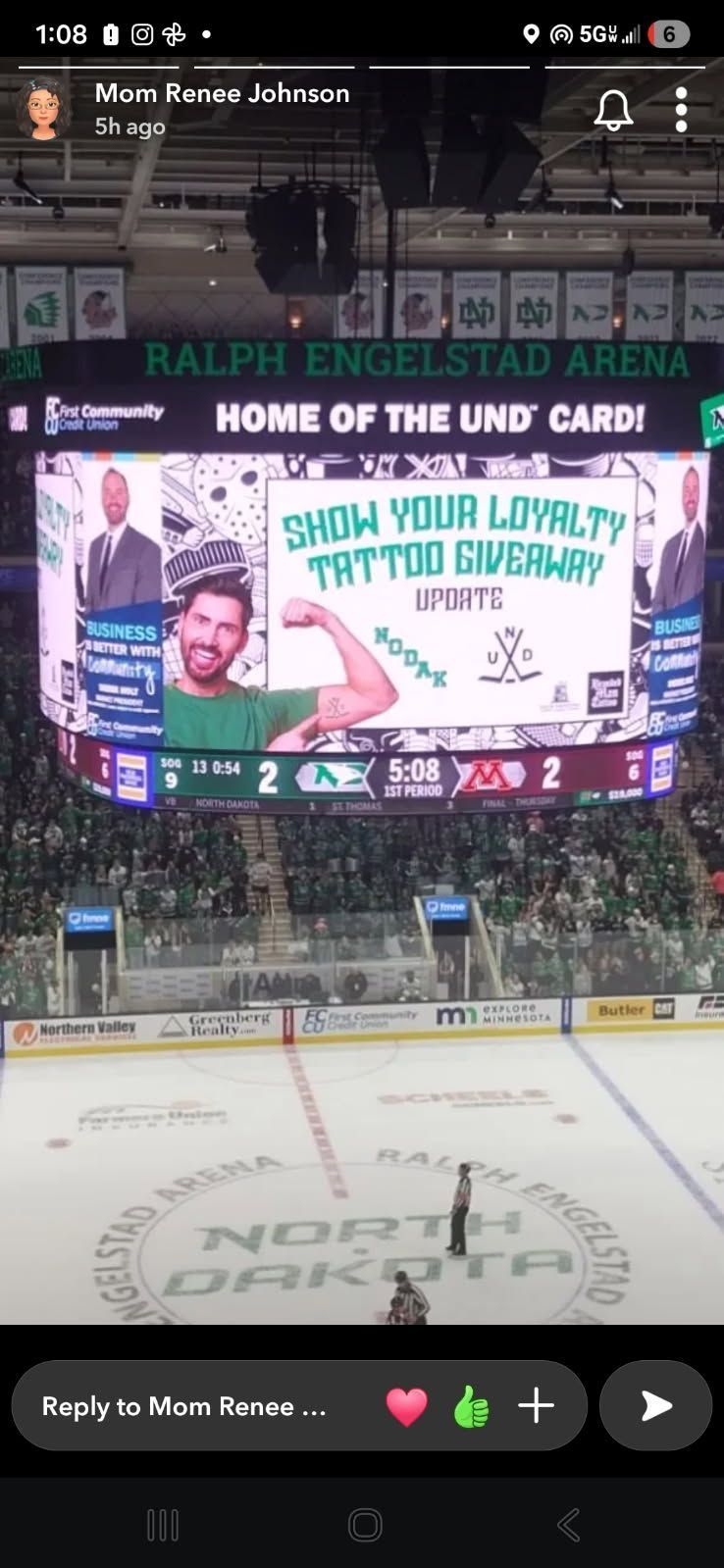 Hockey arena with a scoreboard. Show your loyalty and North Dakota are visible.